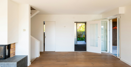 bright room with wooden floors and freshly installed drywall