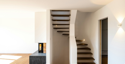 modern staircase and fireplace with clean drywall finish