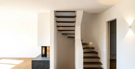 modern staircase and fireplace with clean drywall finish