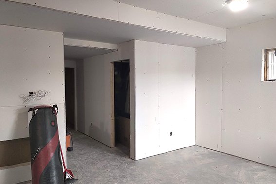 construction area with tools and drywall installation in progress