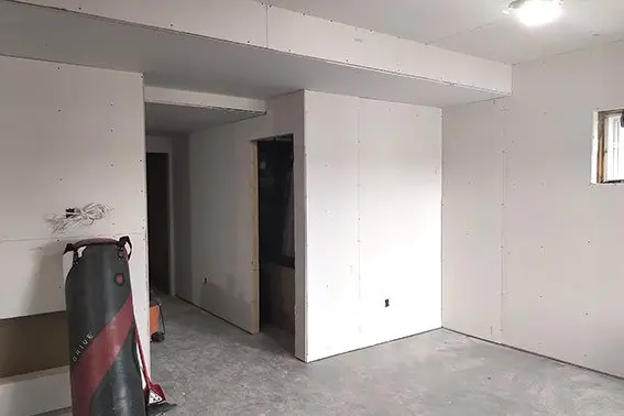 construction area with tools and drywall installation in progress