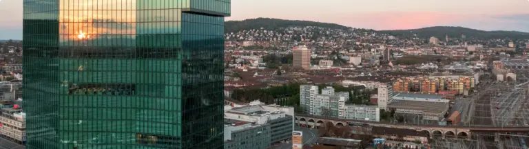 Cityscape with modern high-rise architecture at sunset, symbolizing urban drywall projects by Drywall Express Services. How to Choose the Right Drywall Contractor.