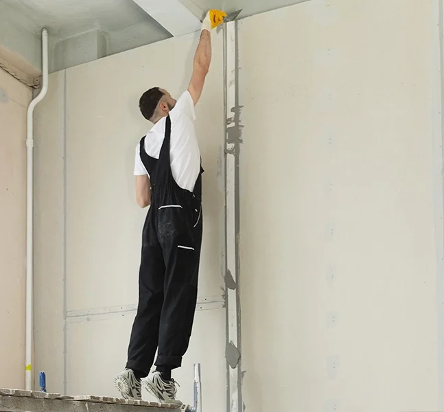 A professional from Express Drywall Services performing drywall work as part of drywall services East Gwillimbury.