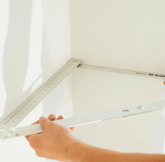Precision corner measurement during drywall services Richmond Hill by Express Drywall Services.