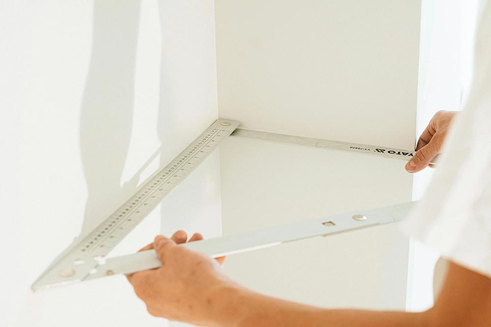 Precision corner measurement during drywall services Richmond Hill by Express Drywall Services.