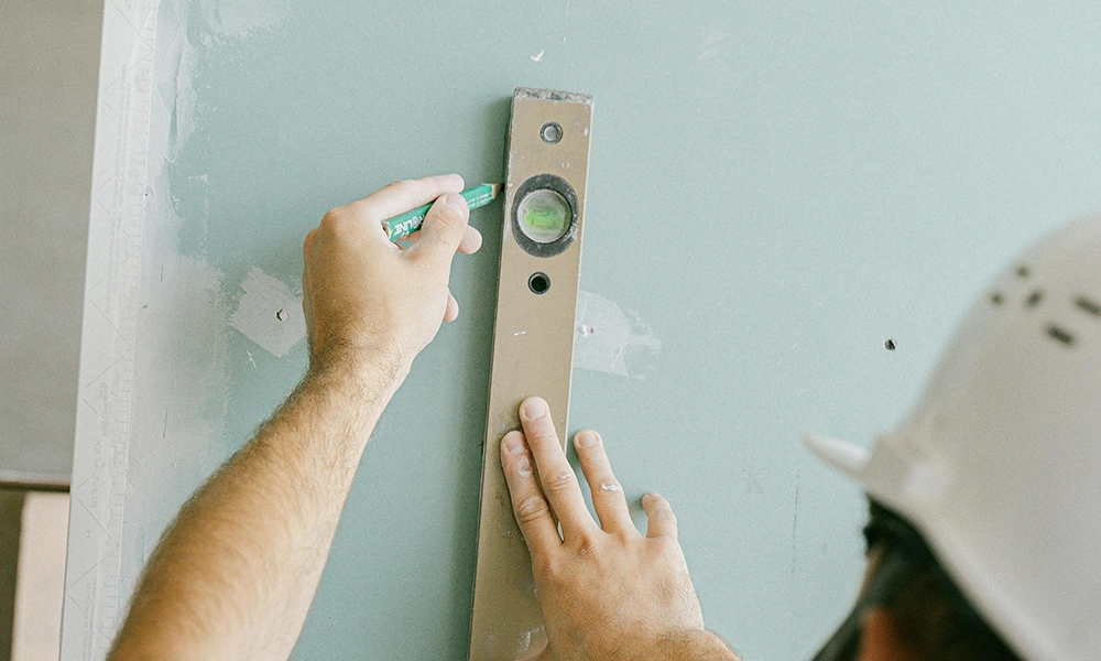 Professional drywall marking during wall installation, part of drywall services Muskoka by Express Drywall Services.