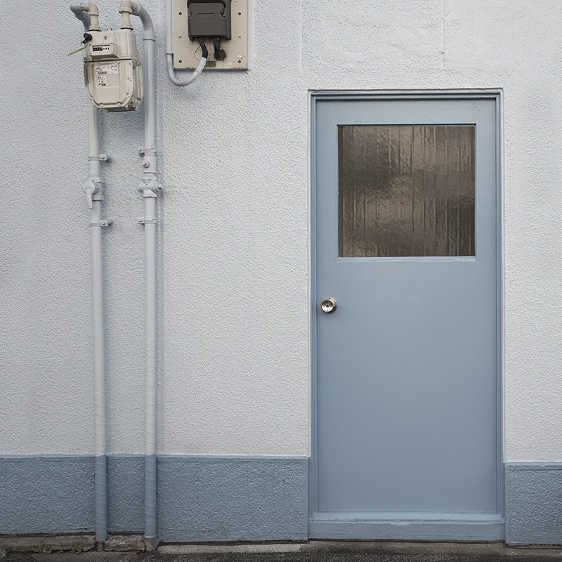 Exterior view of a secured utility area after access door installation by Express Drywall Services.