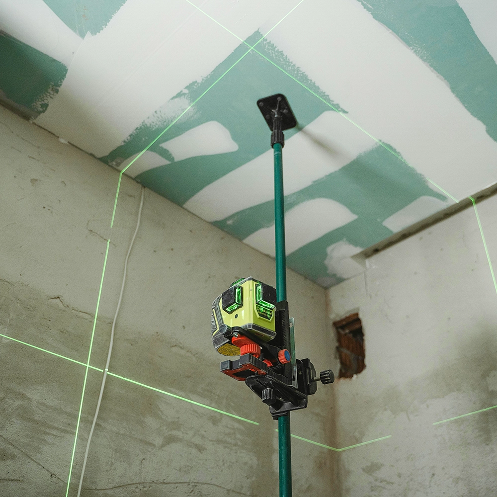 Laser lines mark the wall layout before insulation installation and stickpin insulation by Express Drywall Services experts.