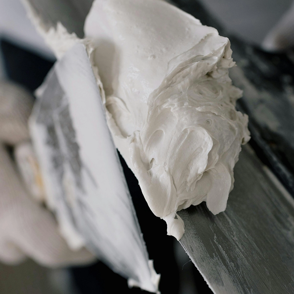 Close-up of joint compound used by Express Drywall Services for high-quality drywall taping and mudding on interior surfaces.