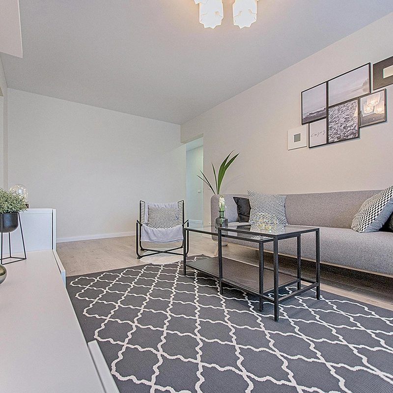 Modern living room featuring clean custom archways and designs by Express Drywall Services for a bright, minimalist space