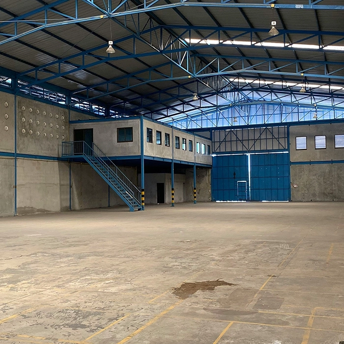 Interior view of a warehouse structure ready for commercial framing installation by Express Drywall Services.