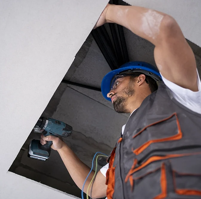 Technician installing ceiling access panel - expert drywall services Halton Hills by Express Drywall Services.