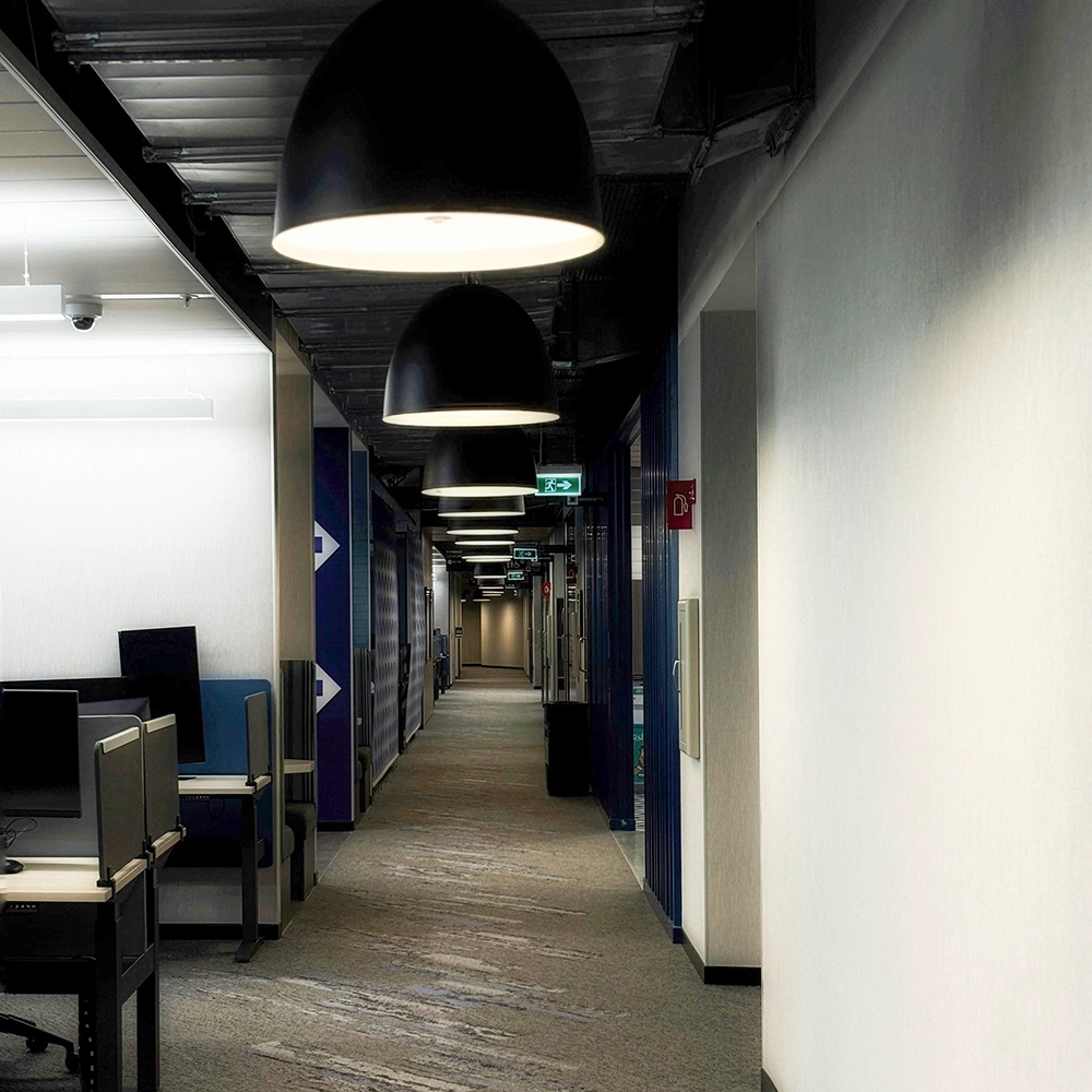 Resilient channel installation in an open-plan office corridor for sound dampening and speech privacy.