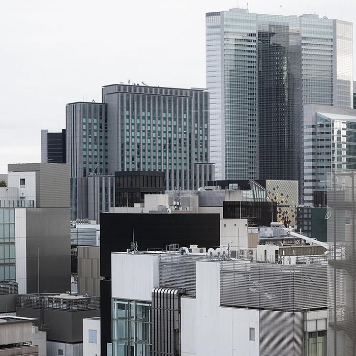 Urban skyline with buildings needing commercial fire and sound separation by Express Drywall Services.