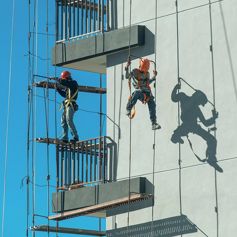 Fire caulking applied during high-rise exterior work for firestop protection.