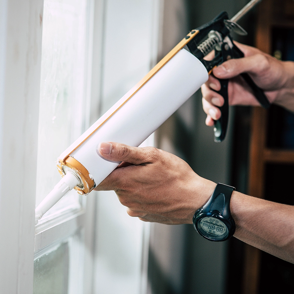 Fire Caulking being applied around a window frame in a new commercial build.