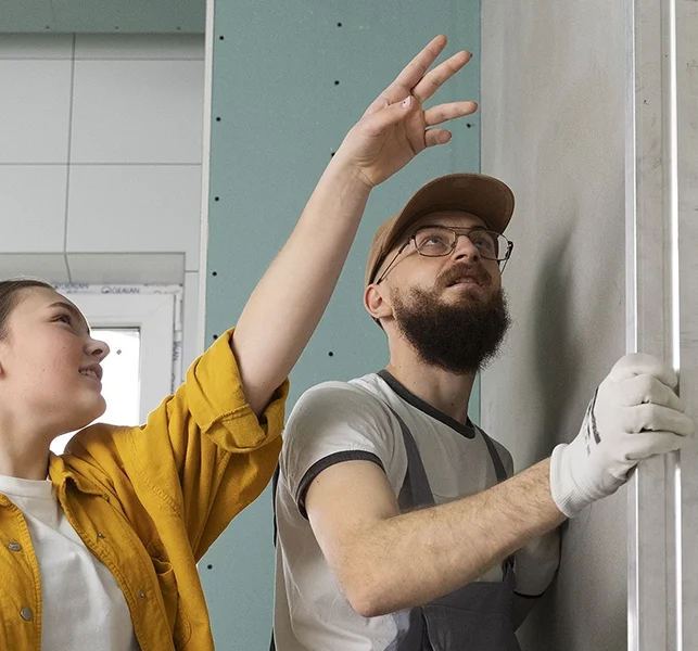 Drywall professionals measuring wall alignment - expert drywall services Nobleton by Express Drywall Services.