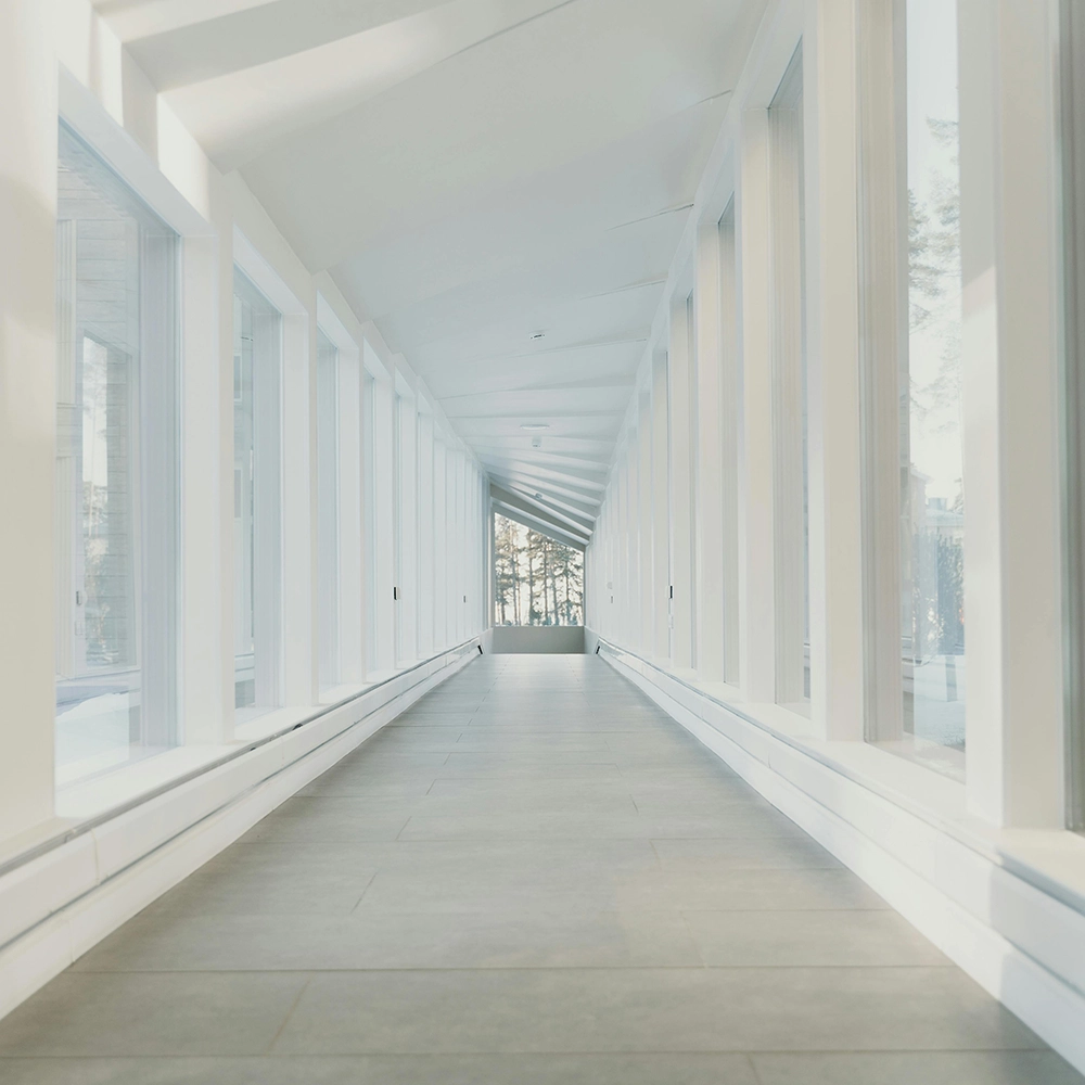 Long residential hallways feature Express Drywall Services fire and sound separation to reduce echo and improve safety.