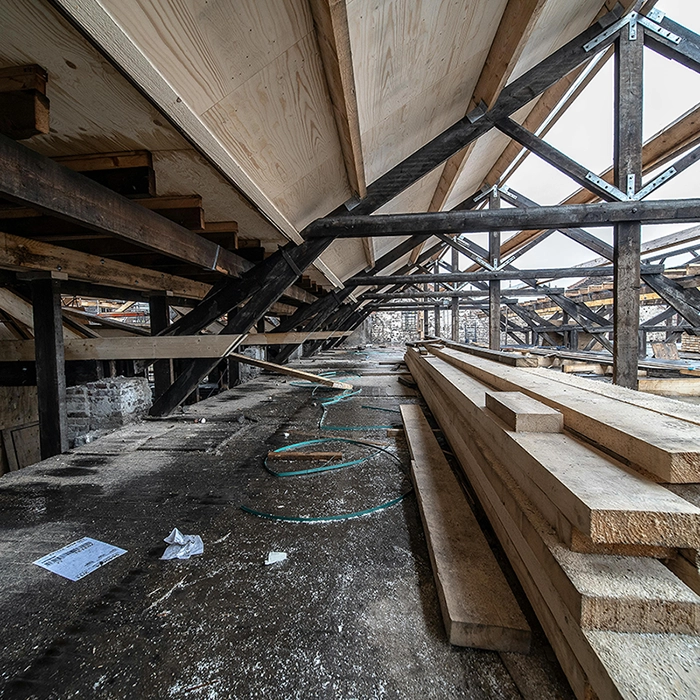 Attic space with exposed wood trusses and framing in early construction phase