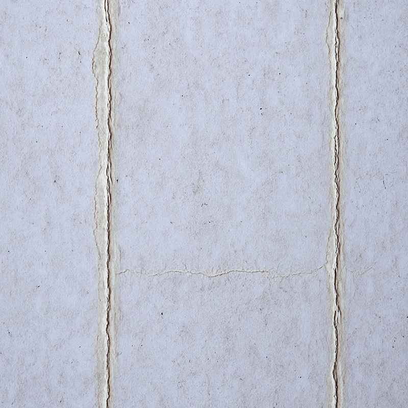 Close-up of seam cracks on old drywall surface, an issue fixed by taping and mudding from Express Drywall Services residential team.