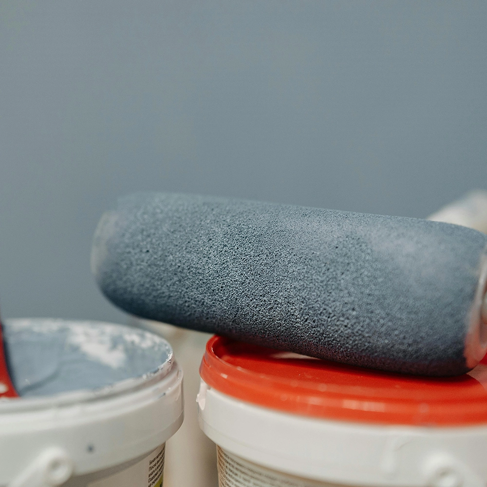 Express Drywall Services residential priming and painting with roller and grey paint buckets