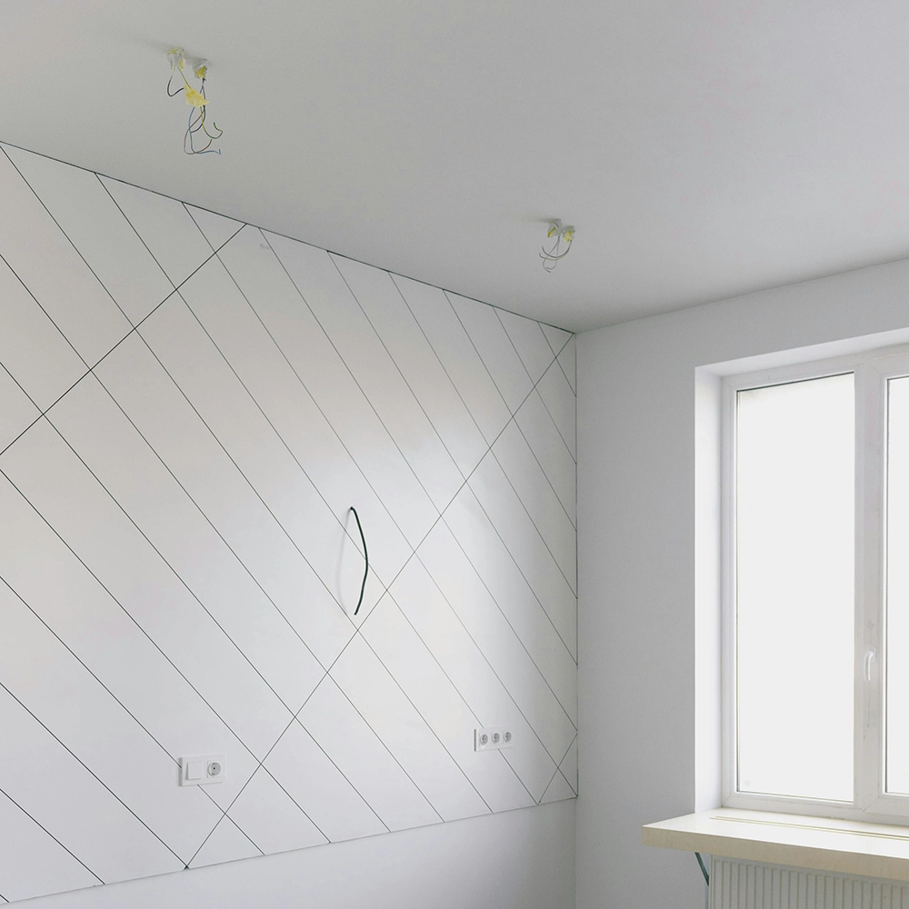 Texturing services by Express Drywall Services applied to a clean, modern accent wall in a bright residential room.