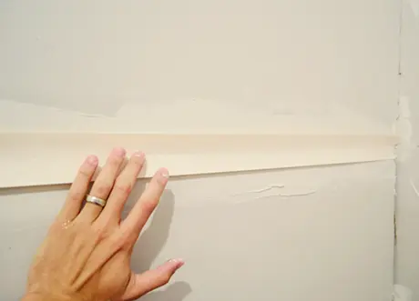 Corner tape being applied during residential taping and mudding by Express Drywall Services.