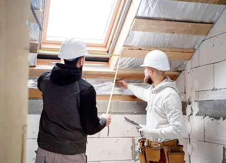 Contractors planning attic insulation installation in home