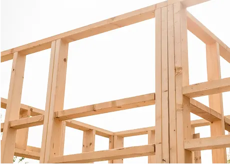 Newly framed commercial structure showing wooden beams by Express Drywall Services