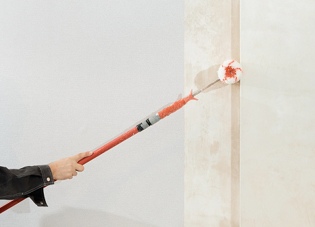 Wall edges being coated with primer in priming and painting by Express Drywall Services