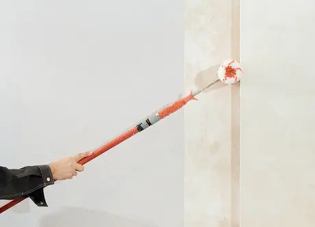 Wall edges being coated with primer in priming and painting by Express Drywall Services
