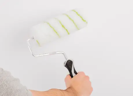 Applying wall primer with roller as part of priming and painting by Express Drywall Services