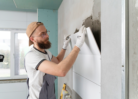 Shower wall tiling during moisture-resistant drywall installation and tile backer by Express Drywall Services