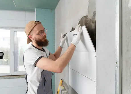 Shower wall tiling during moisture-resistant drywall installation and tile backer by Express Drywall Services