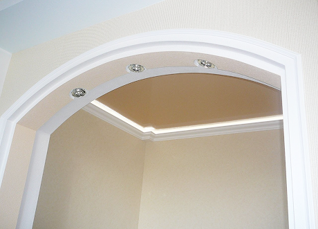 Decorative arch with integrated lighting, part of commercial custom archways and designs by Express Drywall Services.