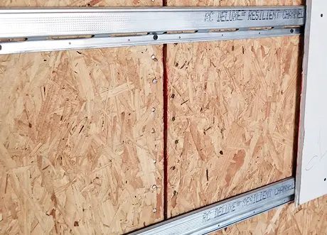 Detail of resilient channel installation on OSB sheathing
