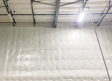 Completed commercial Insulation Installation and stickpin Insulation by Express Drywall Services on high warehouse walls.
