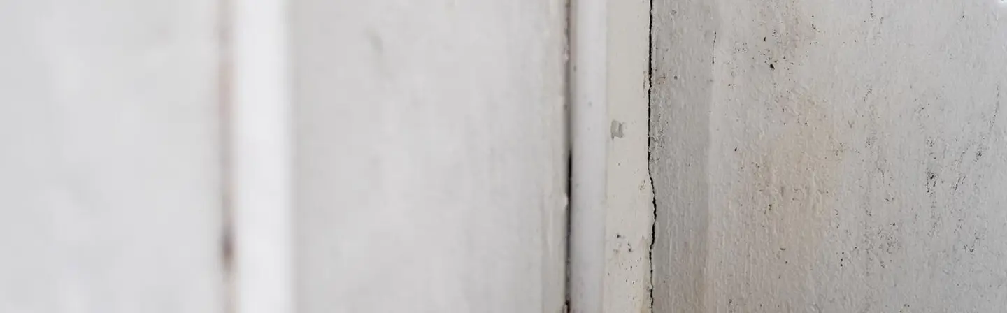 Wall damage and seam separation before drywall repair by Express Drywall Services.