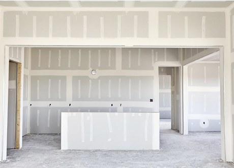 Framed entry and kitchen area after commercial fire-resistant drywall installation by Express Drywall Services.