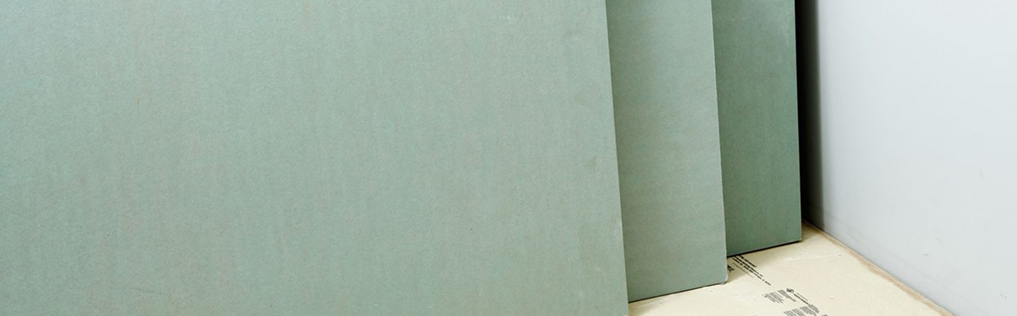 Green boards stacked for moisture-resistant drywall installation by Express Drywall Services.