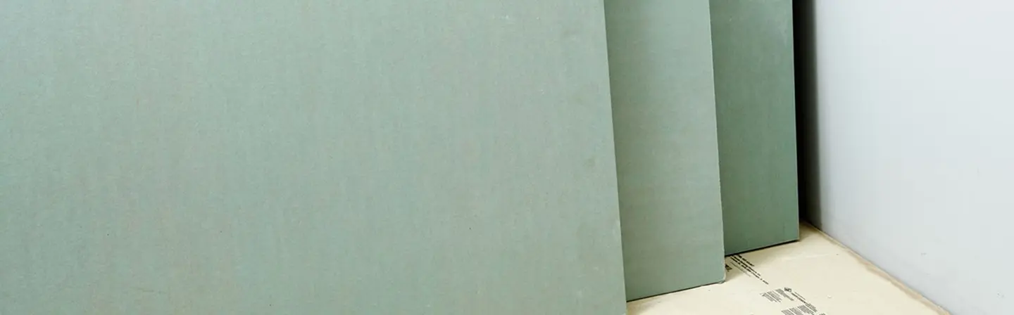 Green boards stacked for moisture-resistant drywall installation by Express Drywall Services.