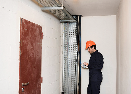 Commercial utility room with metal-framed wall and access door installation by Express Drywall Services.