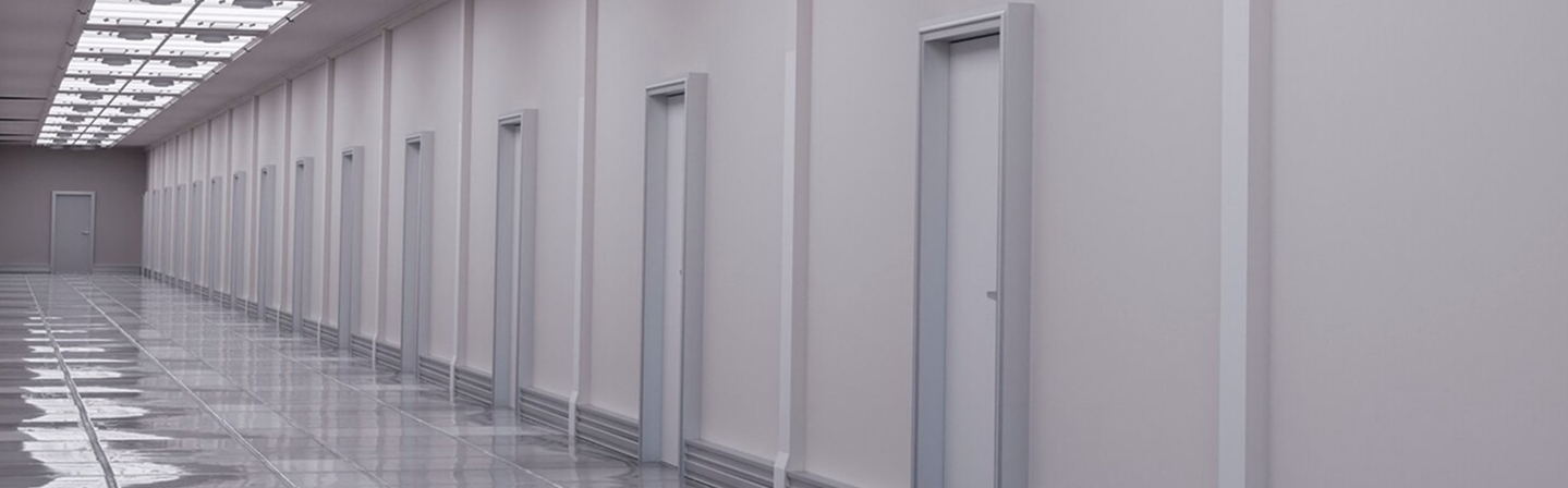 Interior hallway with multiple commercial metal doors by Express Drywall Services