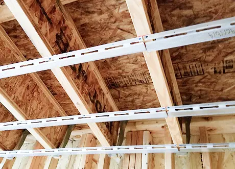 Resilient channel installation on wood joists in commercial ceiling