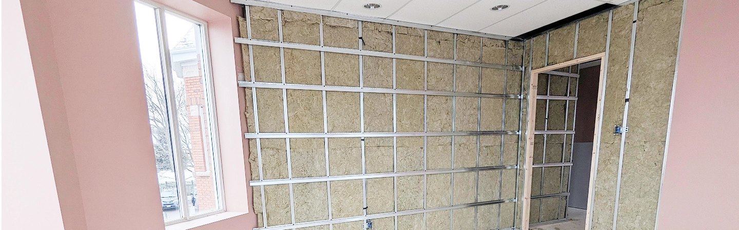 Commercial resilient channel installation behind drywall in progress