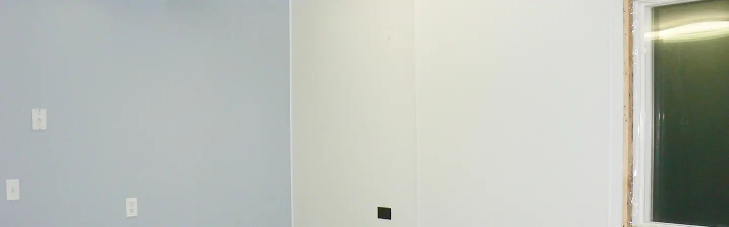 FRP installation on smooth wall surface in a commercial room by Express Drywall Services