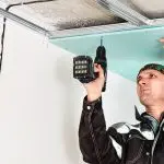 Ceiling panel being installed during residential drywall installation by Express Drywall Services.