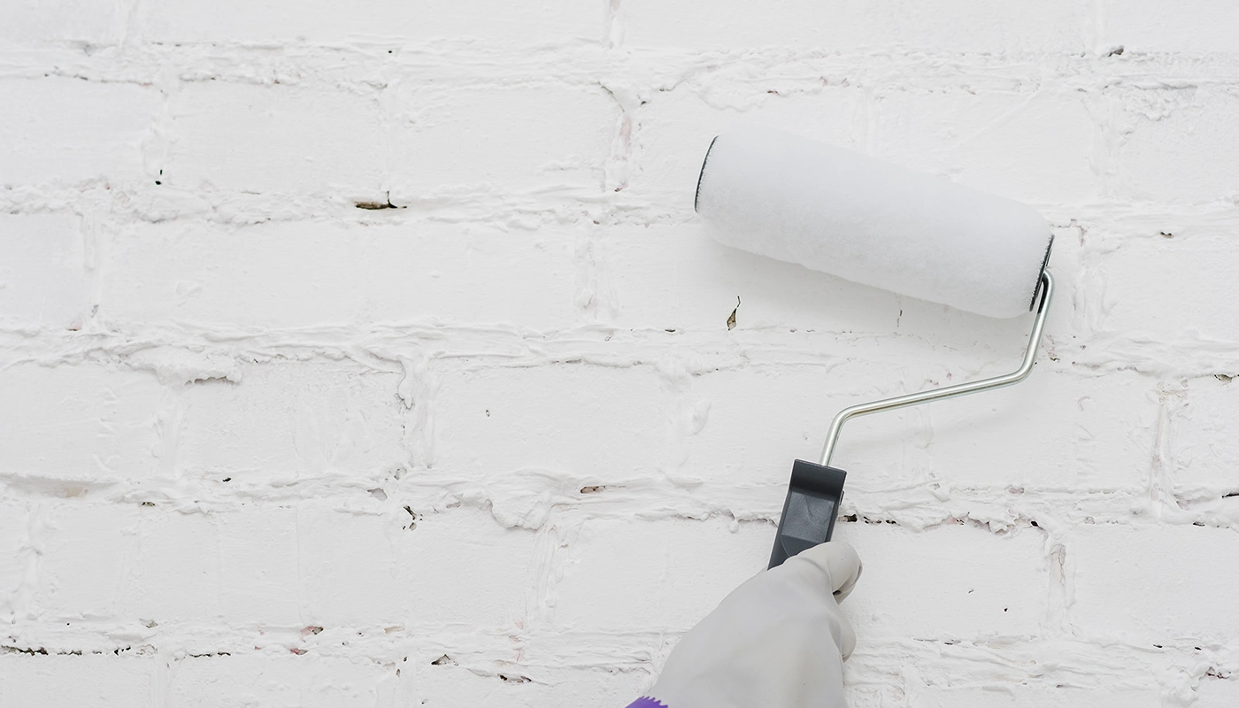 Roller applying primer during priming and painting in Toronto by Drywall Express Services.