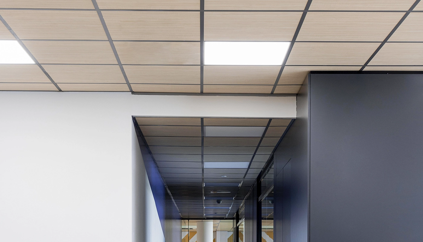 Wooden texture t-bar and drop ceiling in Toronto office hallway completed by Drywall Express Services.