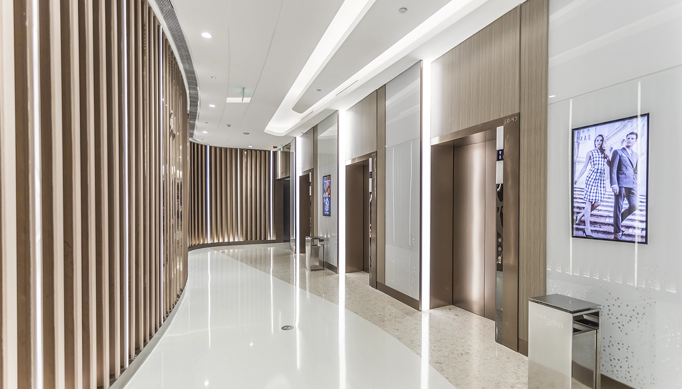 Modern commercial hallway with wood panel detailing – ideal for fire and sound separation in Toronto by Drywall Express Services.